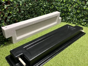 This is a picture of the bed block mold with a finished poured concrete block behind it.