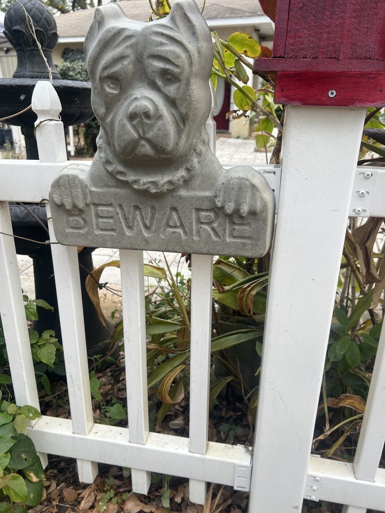 Beware sign on fence