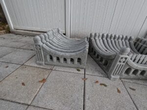 Stacked finished concrete fence panels made from the Regal Arch Mold, showing multiple pieces ready for installation.
