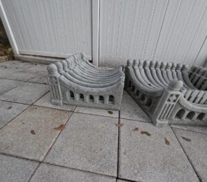 Stacked finished Regal Arch concrete fence panels made from the Regal Arch Concrete Mold, showing multiple pieces ready for installation.