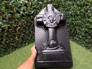 Fireman Cross concrete mold shown by hand for size reference