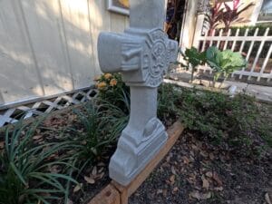 Finished Fireman Cross concrete memorial displayed in a garden setting