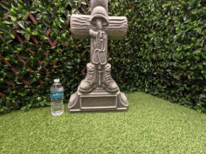 Concrete battlefield cross statue made using a reusable mold from ABSMolds.com shown with water bottle for size comparison