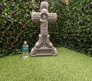 Concrete battlefield cross statue made using a reusable mold from ABSMolds.com shown with water bottle for size comparison